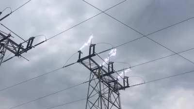 The forming and breaking of a large electrical arc (lightning bolt) as a high-voltage disconnect switch is opened.