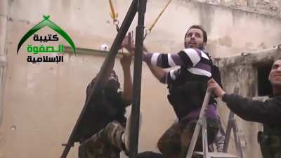 FSA fighters rig a slingshot to launch improvised grenades in order to harass SAA controlled positions - Aleppo - 11/28/2013