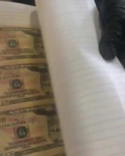 Federal agents discovered a book with counterfeit currency, but only after flipping though it in the opposite direction