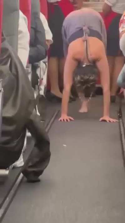 woman doing yoga on a flight from ibiza to manchester