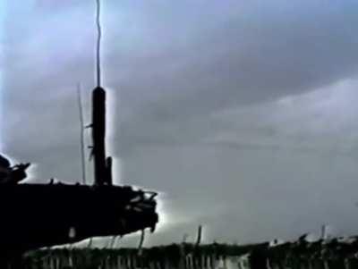 Marines watch from the ground as an attack helicopter engages forces of Mohamed Farrah Aidid in Somalia, January 1993.