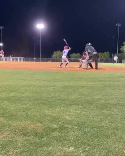 Kid makes contact with the pitch and a foul ball from another field on the same swing