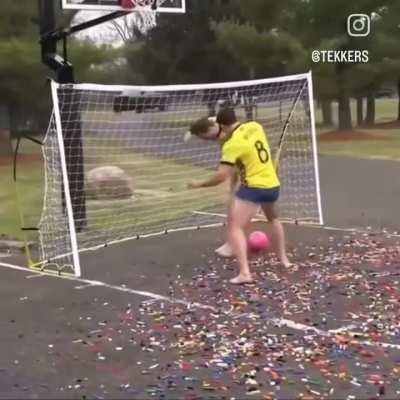 Football with bowling ball on lego field 