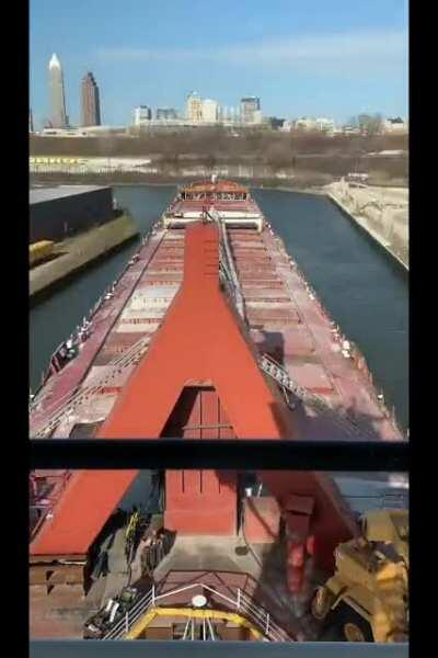 Freighter navigating outbound on the Cayahoga river Cleveland Ohio.