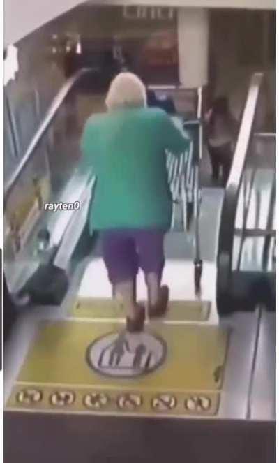 Old woman introduces a shopping cart to an escalator