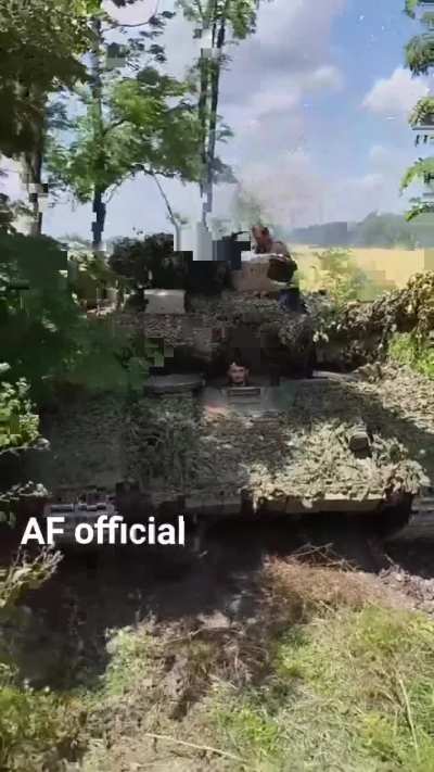 A Ukrainian T-64BV tank leaves concealment and drives away.