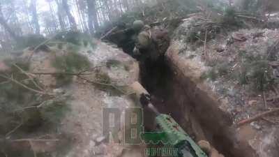 First person POV footage of Russian forces assaulting an entrenched Ukrainian position in the Kremmina forest, killing Ukrainian soldiers, taking one as a POW, and treating a wounded comrade