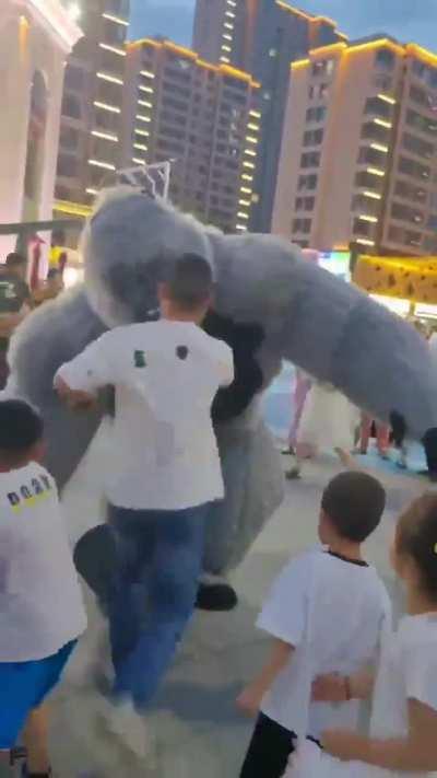 Father kicks man in an inflatable gorilla suit after a kid is accidentally kicked down