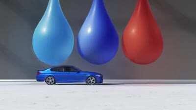 Popping giant water balloons with a car.