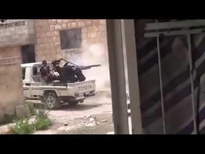 FSA Rebel firing an AA gun mounted on a Technical hits ally, Aleppo - Syria - 2013