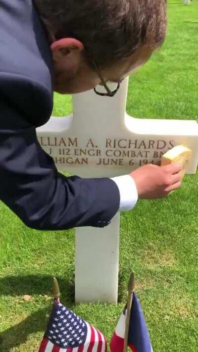 Sand from Omaha Beach is used to make the names on white crosses more visible