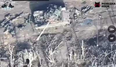About 20 Russian soldiers scattered around a tank. Drone video of battlefield. Ukraine, 2024.