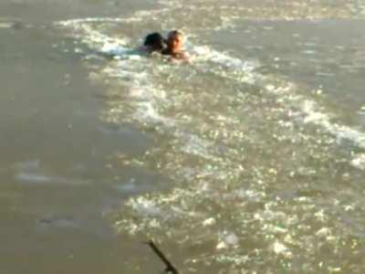 Man smashes through icy river to save his dog