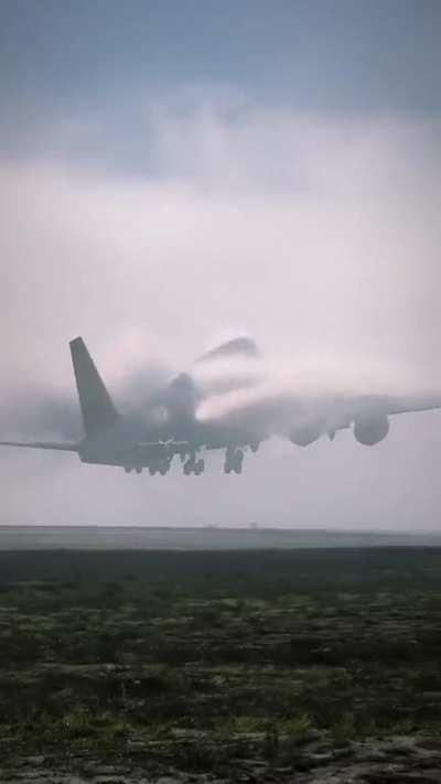 Plane taking off into misty clouds