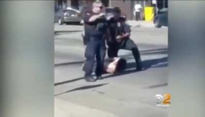 Federal Officers shown kicking handcuffed suspect in the head