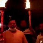 Indian citizens stand together with flaming toilet plungers and chant to protest the coronavirus.