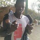 A talented musician from Senegal playing around with a couple gourds attached to strings