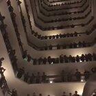 The Colorado All-State Mixed Choir singing from the balcony of the hotel they were staying at