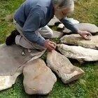 Archaeologist Dr. Jean-Loup Ringot specialized in prehistoric music demonstrates a Lithophone.