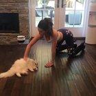 Kate Beckinsale on all fours playing with her kitty.