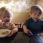 This sister feeding her brother his breakfast and asking him repeatedly, “Like it?”