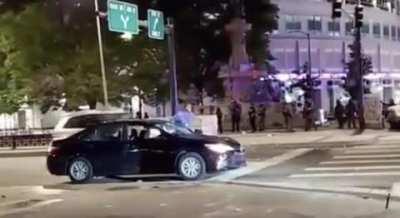 This man isn't a protester. He was just a guy sitting at a traffic light when cops shot his car with a tear gas round. He got out to yell at them because his pregnant wife is in the vehicle. So they opened fire on them.