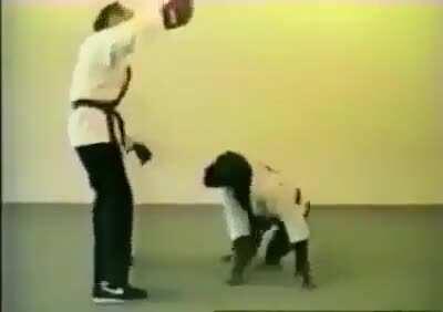 Man teaching an ape personal defense moves