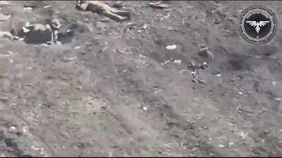 Ukrainian FPV drone hits two Russian soldiers near a destroyed BTR somewhere in the east