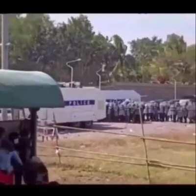 Girl with red cloth got shot in head in myanmar's protest by the police with BA-94 SMG(Submachine Gun) 9×19mm(U can see the shooter at the end of video)