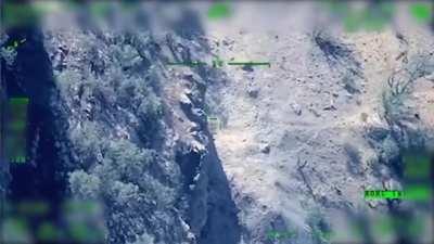 Turkish Armed Forces follow PKK militants to their cave and hit the cave. Bayraktar TB2 UAV POV. Date and place unknown.(music from source)