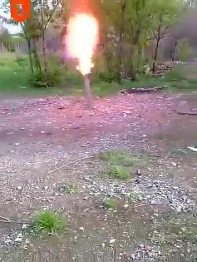 Man pits a lit cigarette into a tube and it bursts into flames