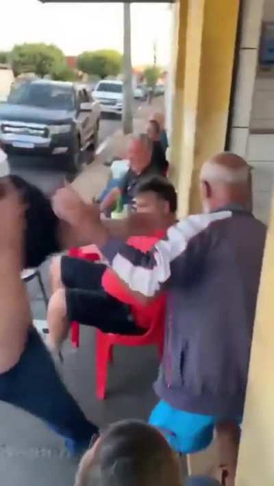 Drunkards attempting to have a serious street fight outside the bar