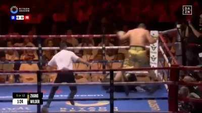 Why did Wilder turn his head and let Zhang knock him out? Is he stupid?