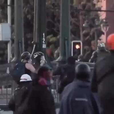 Chilean cop push a minor protester off a bridge.