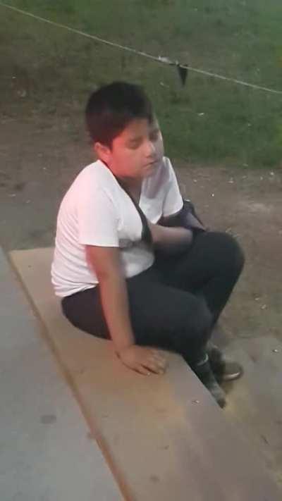 This kid trying not to fall asleep at an amusement park.