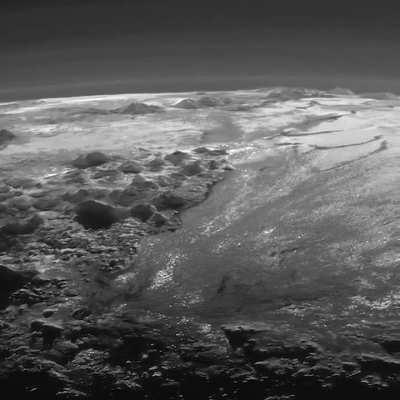 Pluto's ice mountains, frozen plains and layers of atmospheric haze backlit by a distant sun, as seen by the New Horizons spacecraft.