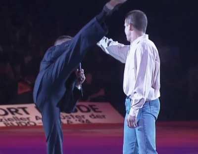 Jean-Claude Van Damme demonstrates his signature kicks in a suit - 1994