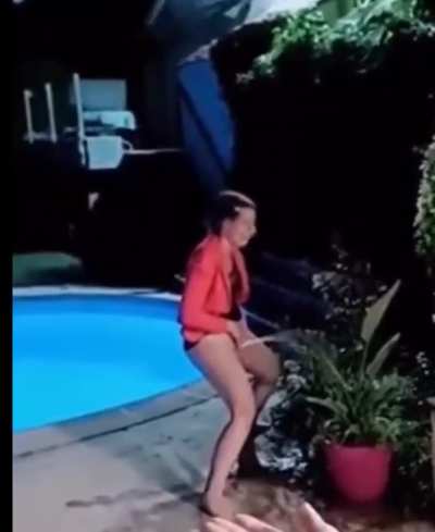 French girl peeing standing by the pool