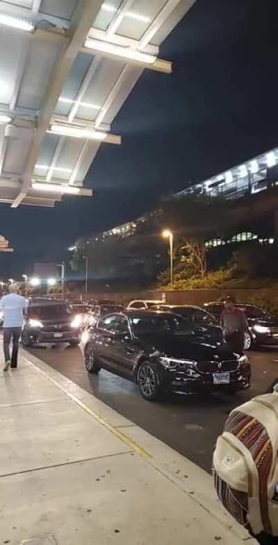 This man in the airport passenger pickup loop put his car in park and stood in the road for ten minutes waiting for whoever he was picking up. Meanwhile, the entire line gets backed up.