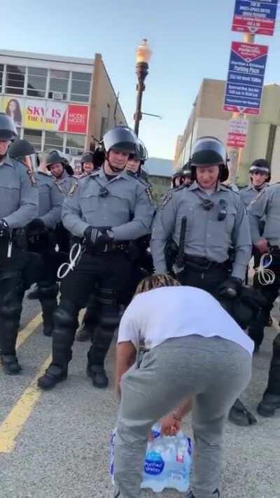 One of the organizers of a peaceful demonstration in Pittsburgh gives the state police water that was donated to protesters (xpost r/MadeMeSmile)