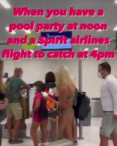 Air passenger filmed walking through a US airport in just a bikini and a face mask