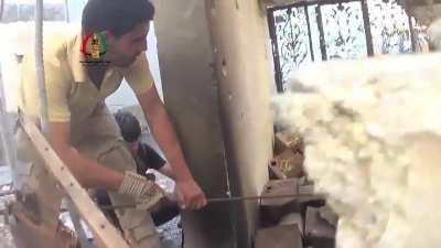 Opposition fighters struggling to retrieve the body of their fallen comrade appear to come under direct fire - Daraa al-Balad - 6/15/2014