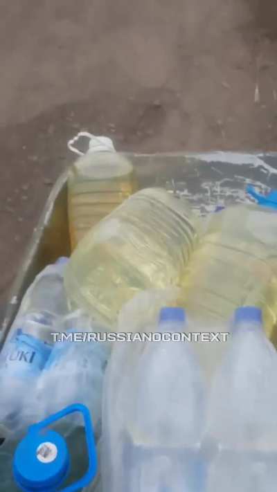 A Russian serviceman transports gasoline and water in a wheelbarrow for 3 km (1.8 miles) to his position, already thinking about where to find a motorcycle. Location: Novomikhaylovka, Donetsk region.