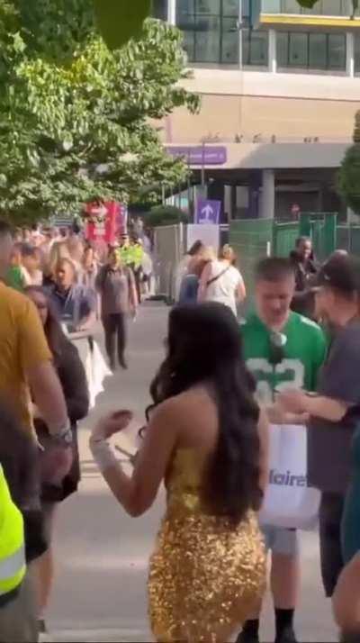 Jason Kelce greets a fan wearing his Eagle jersey in London.