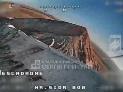 Russian soldier walking on top of the well-known waste heap finds a Ukrainian FPV drone