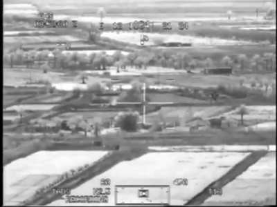 AH-64 Apache taking out a building suspected of hiding IED team in Iraq in 2007, seen through the FLIR of an accompanying AH-64