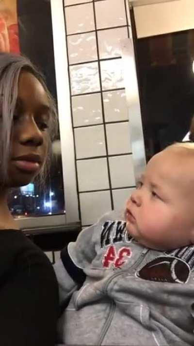 adult who 'Appears' to be a baby stares at Woman, throws a winning smirk