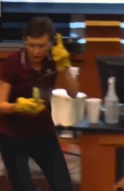 Tatiana Erukhimova, professor of physics and astronomy at Texas A&M University, conducts physics experiments for a group of children on how to build a house out of wood, nails and frozen bananas.