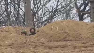 UA soldier gets helmet blown off by marksman during combat in Ukraine.