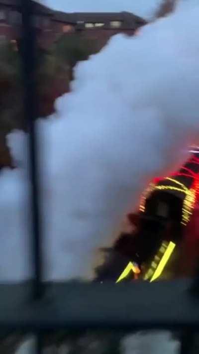 A steam engine train wrapped with christmas lights